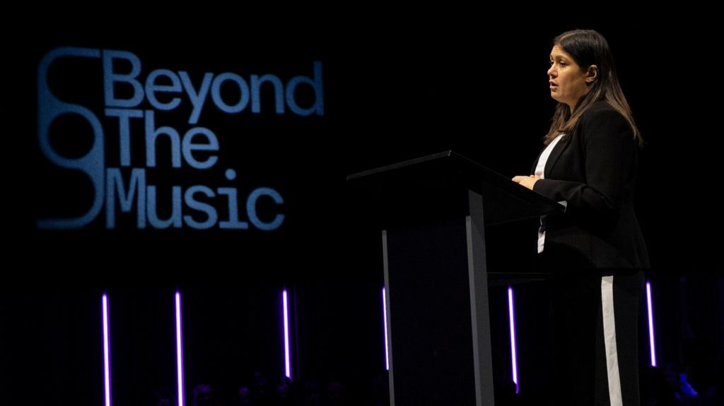 Culture Secretary Lisa Nandy speaking with a Beyond the Music logo behind her