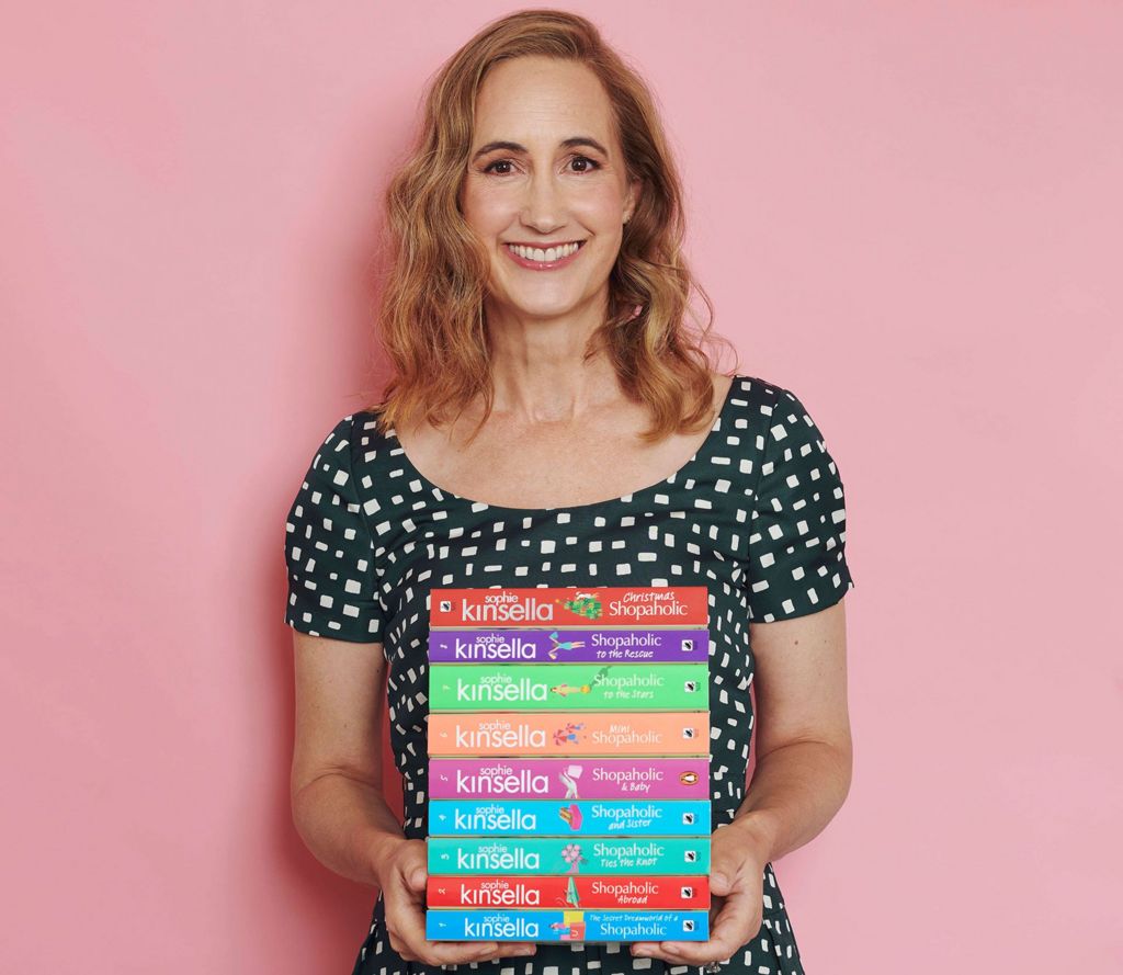 Sophie Kinsella pictured with hr Shopaholic series of novels