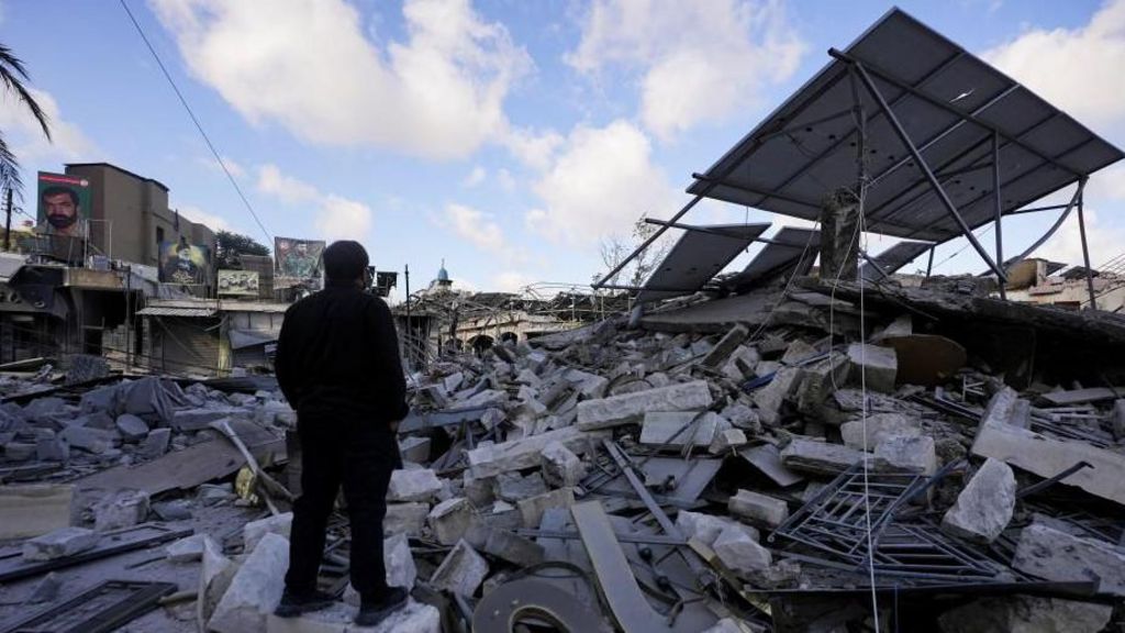 A man inspects the damage in the aftermath of Israeli strikes in Nabatieh, Lebanon, June 15