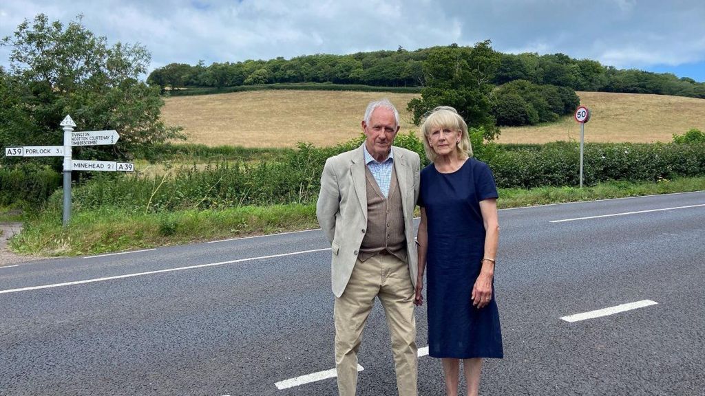 Peter Bate stands next Scilla Barney on the A39 road near Tivington