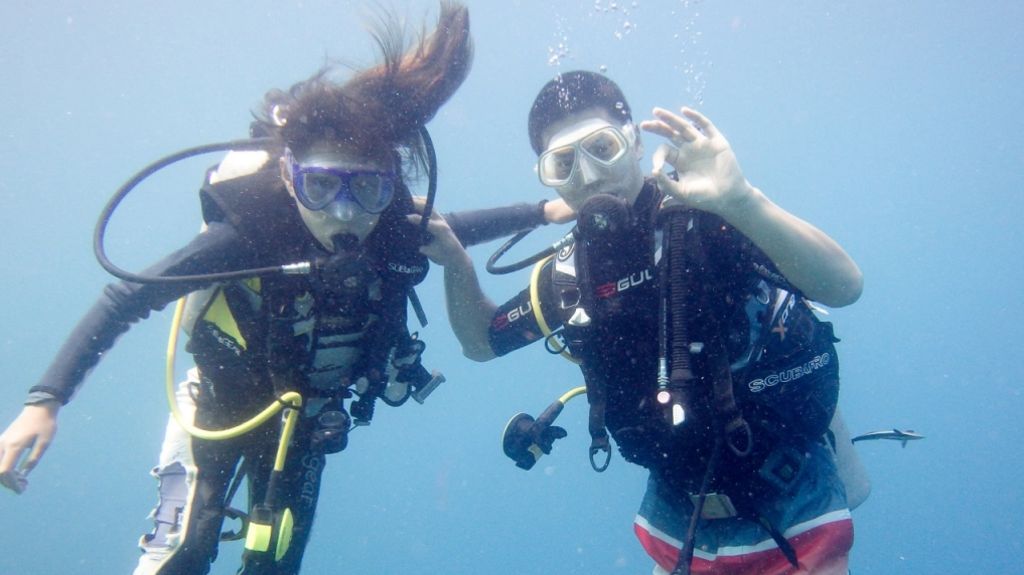Caitlyn Scott-Lee scuba diving with her father
