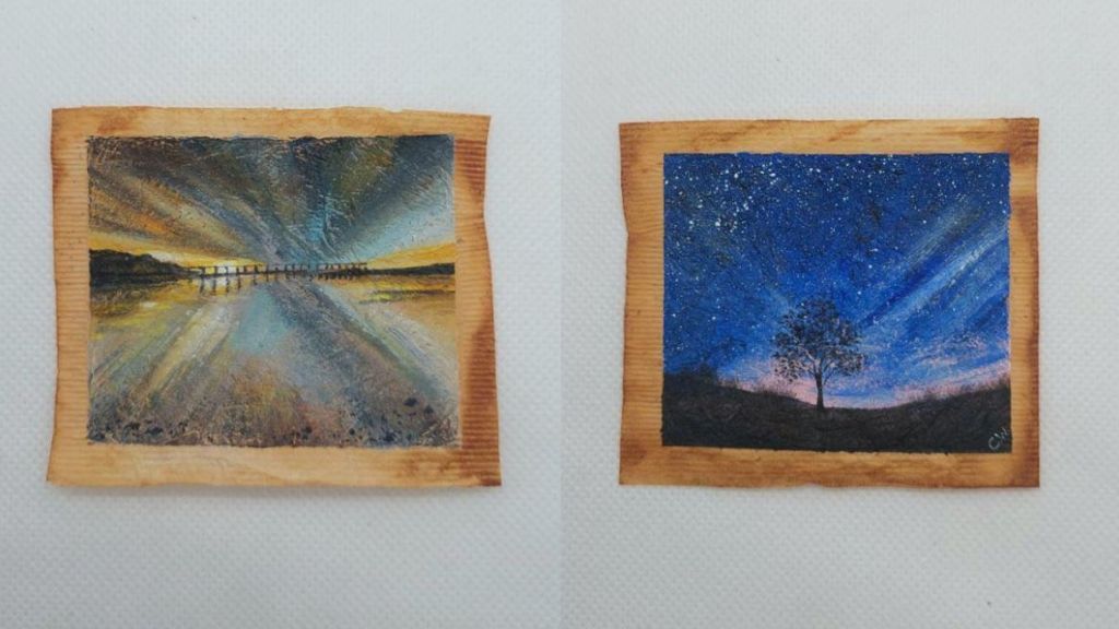 Two teabags - one with a paintings of Salturn Pier in pastel colours and the other with an image of a lone tree at nightfall on Yorkshire Dales, with stars on a navy sky