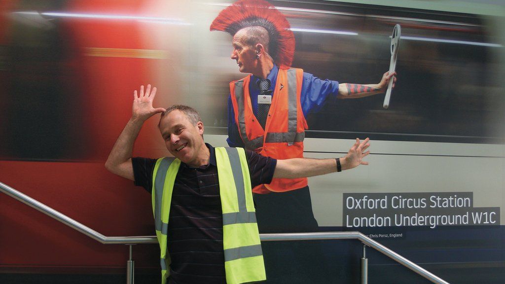 Chris Porsz with one of his images at a London Luton airport exhibition.