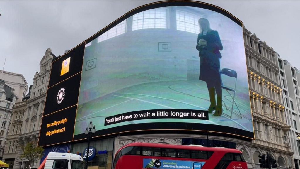 Screen at Piccadilly Circus showing a still of the film