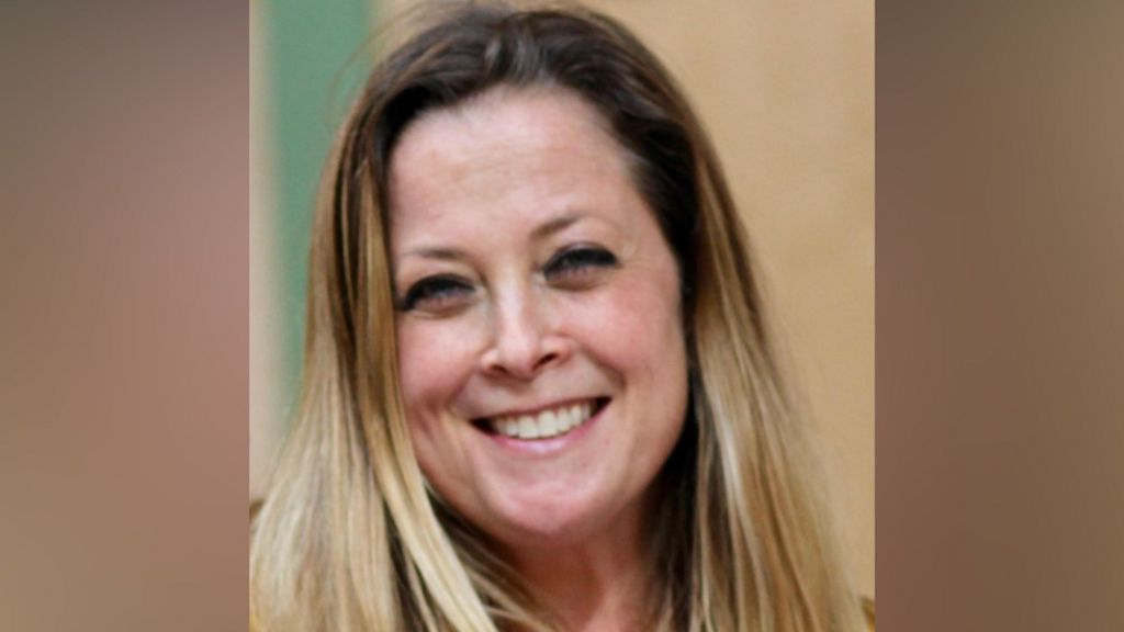 Annabel Rook, a woman with blonde shoulder-length hair, smiles and looks into the camera. 