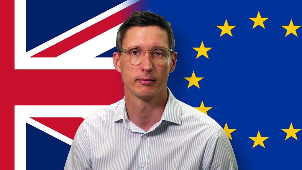 Jonathan Blake in front of UK and EU flags