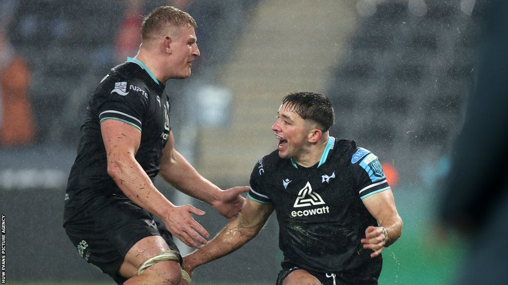 Ospreys fly-half Dan Edwards is congratulated by Jac Morgan after scoring a try on his league debut