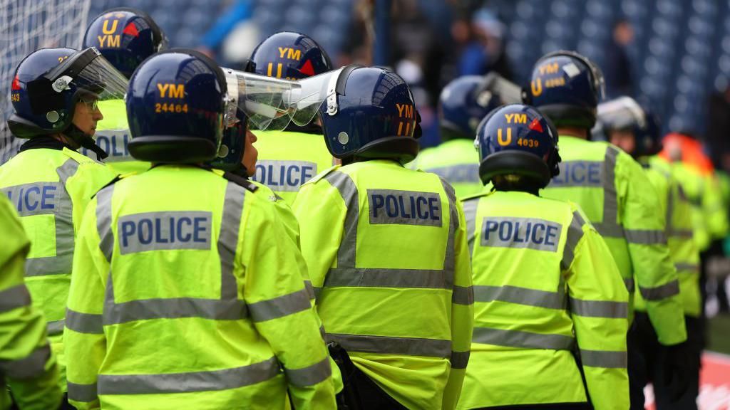 Police officers surround the pitch during the Emirates FA Cup Fourth Round match between West Bromwich Albion and Wolverhampton Wanderers