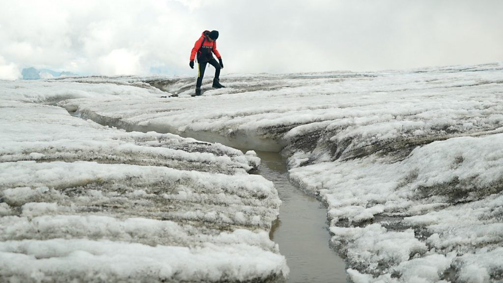 Man walks across a crack in the ice