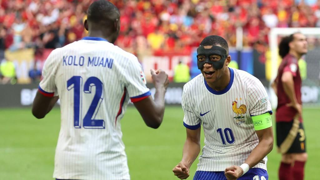 Kylian Mbappe celebrates a France goal with Randal Kolo Muani