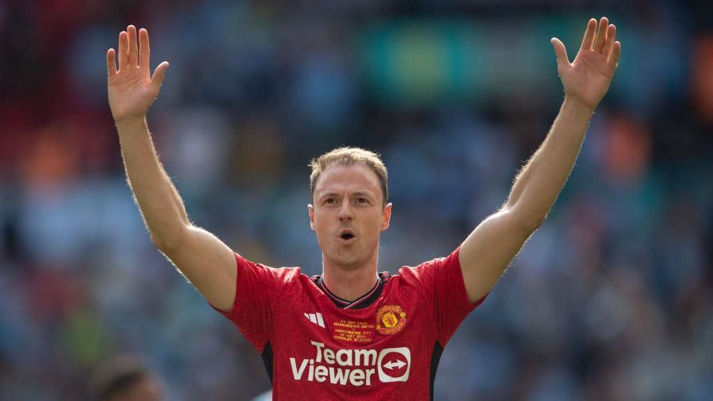 Jonny Evans celebrates winning the FA Cup 