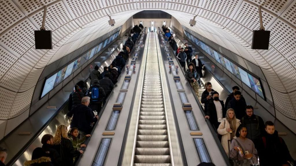 Commuters on escalators in Elizabeth Line station
