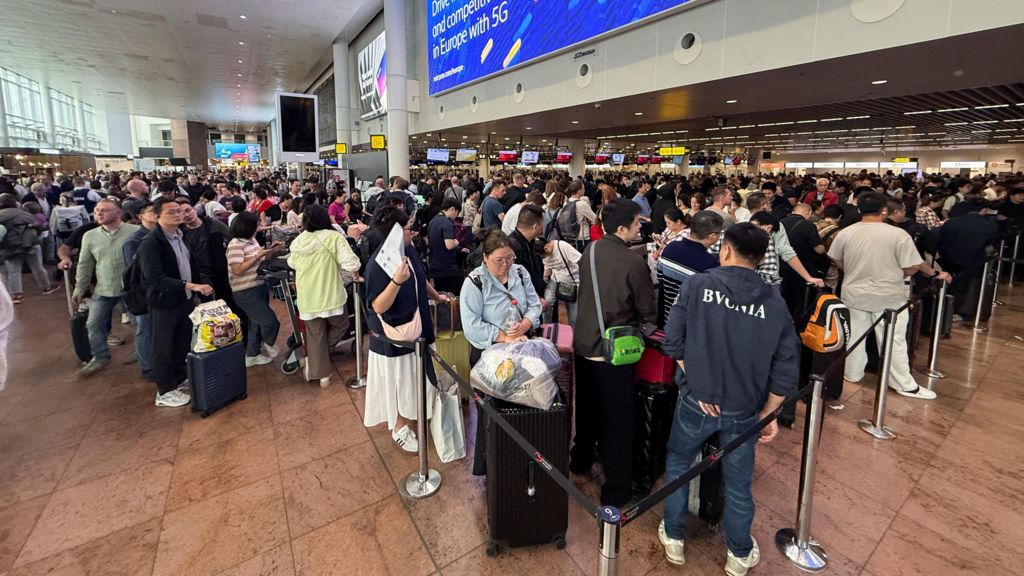 Long queues and large crowds seen stretching across the terminal at Brussels Airport on Saturday morning