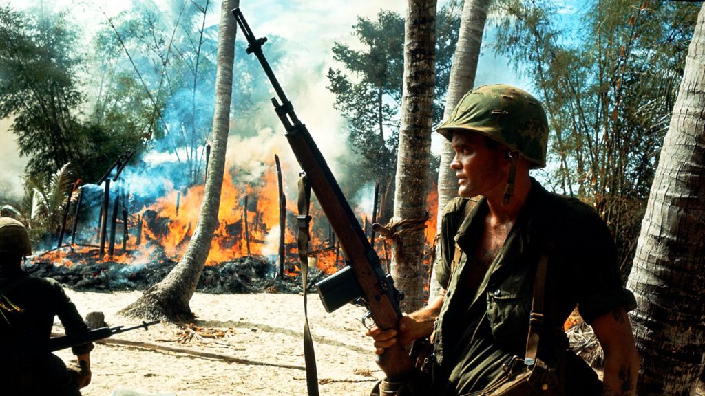 US soldiers in a burning village during the Vietnam War, circa 1965