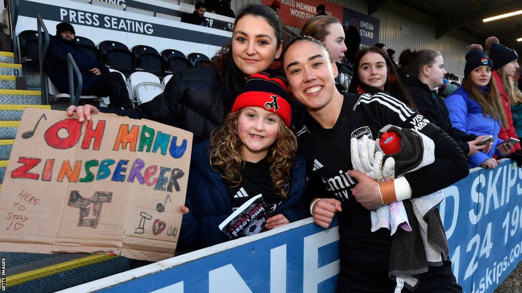 Manuela Zinsberger celebrates with fans at Meadow Park