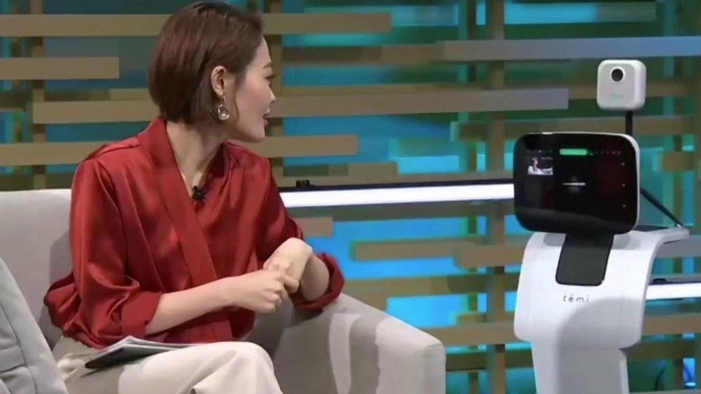 A Temi robot takes a patient's temperature remotely