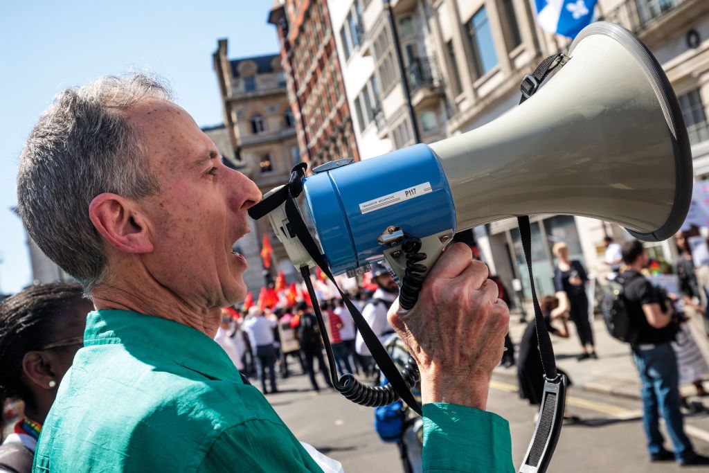 Peter Tatchell at a protest, talking into a loud speaker
