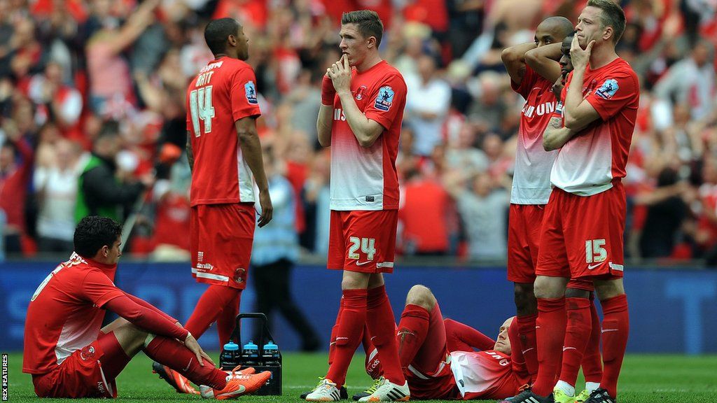 Leyton Orient players react after losing the League One play-off final on penalties in 2014