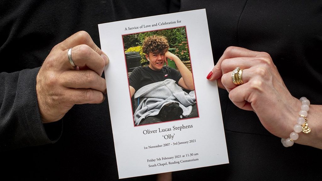 Stuart and Amanda hold the card for Olly's memorial service