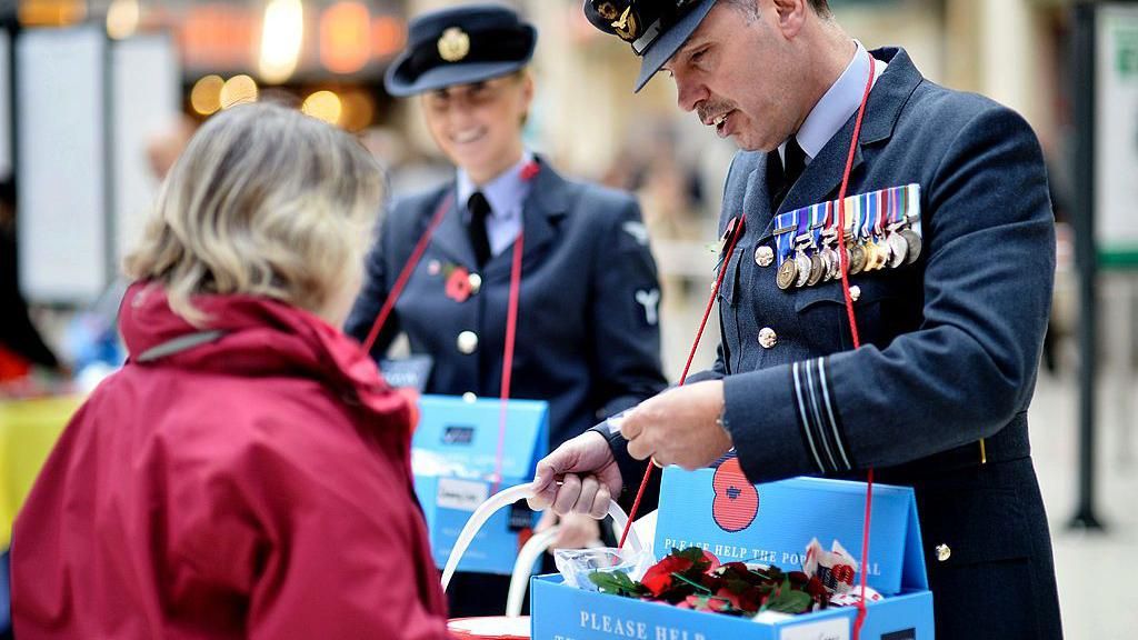 Members of the armed forces selling poppies in London