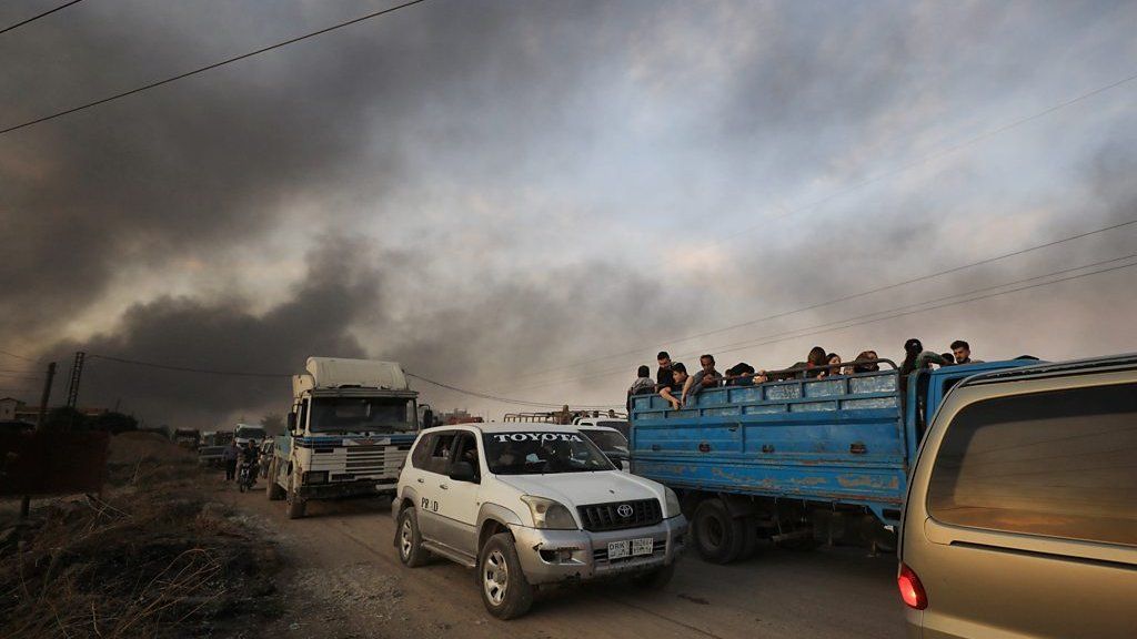 People in trucks near Ras al-Ain in Syria