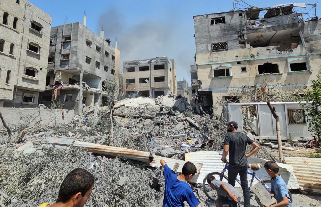 Palestinians inspect a house hit in an Israeli strike, due to an Israeli military operation, amid the Israel-Hamas conflict, in Nuseirat refugee camp, in the central Gaza Strip