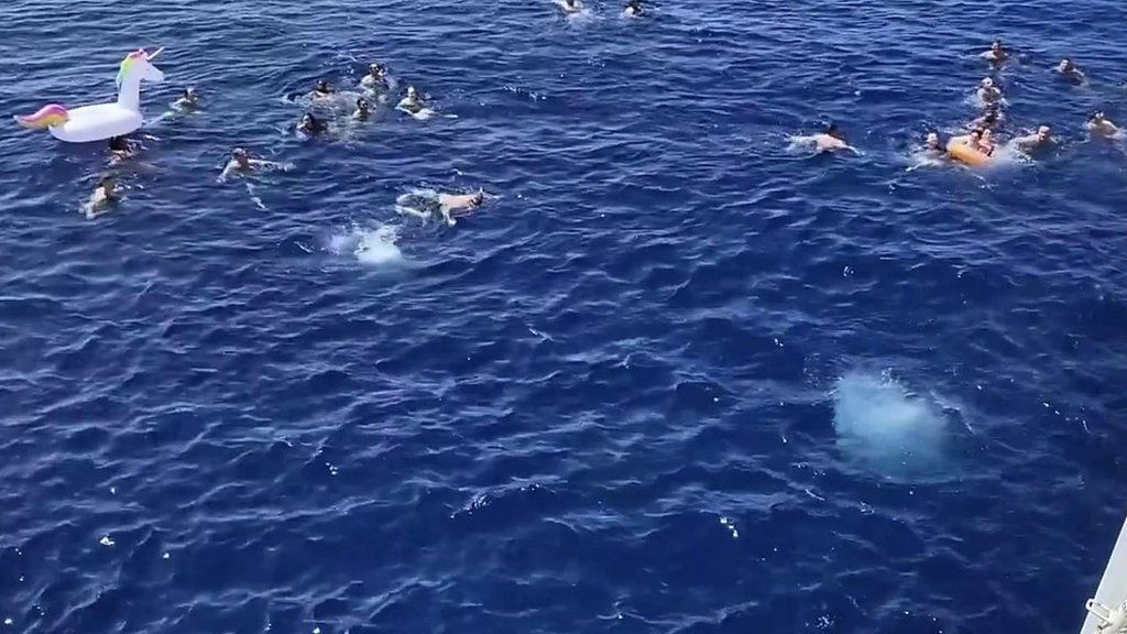 People swimming in ocean