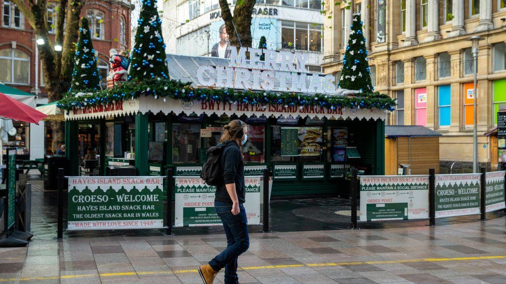 A man passes a festively decorated Hayes Island Snack Bar in Cardiff city centre