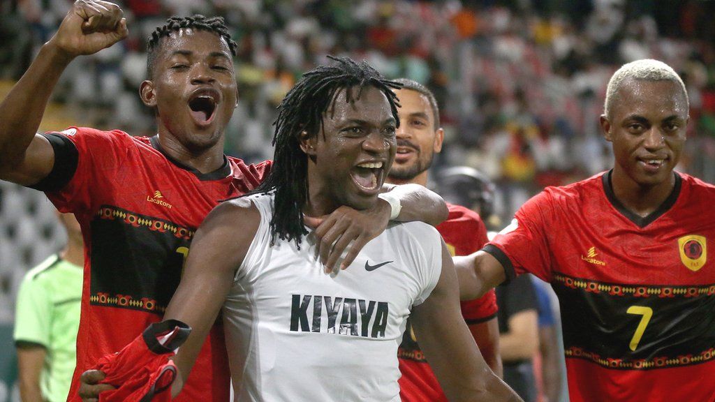 Angola striker Mabululu (second left) celebrates his goal against Burkina Faso that helped the country finish top of a Nations Cup group for the first time