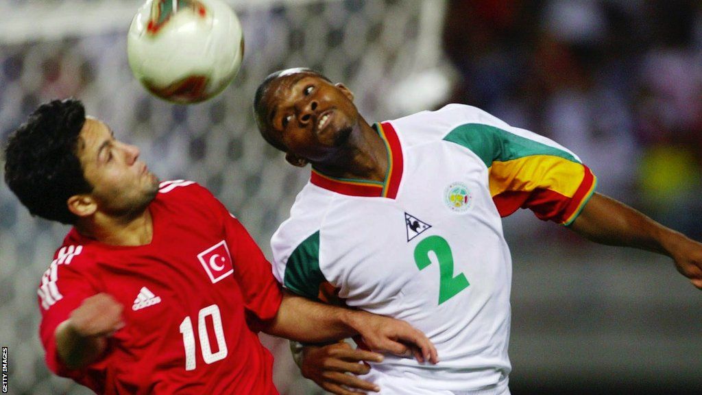 Yildiray Basturk and Omar Daf challenge for the ball at the 2002 World Cup