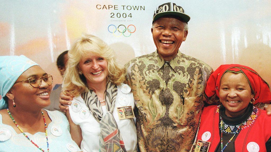 South African President Nelson Mandela (centre right) is surrounded by employees as he visits the Cape Town stand in the Palais de Beaulieu in Lausanne in September 1997