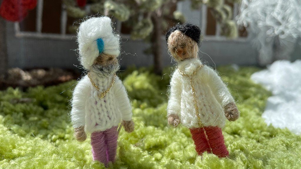 Two knitted figures.