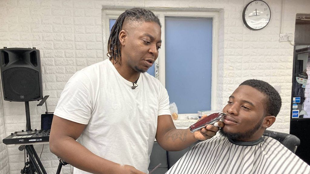 Mitch the barber giving Kwaku a trim