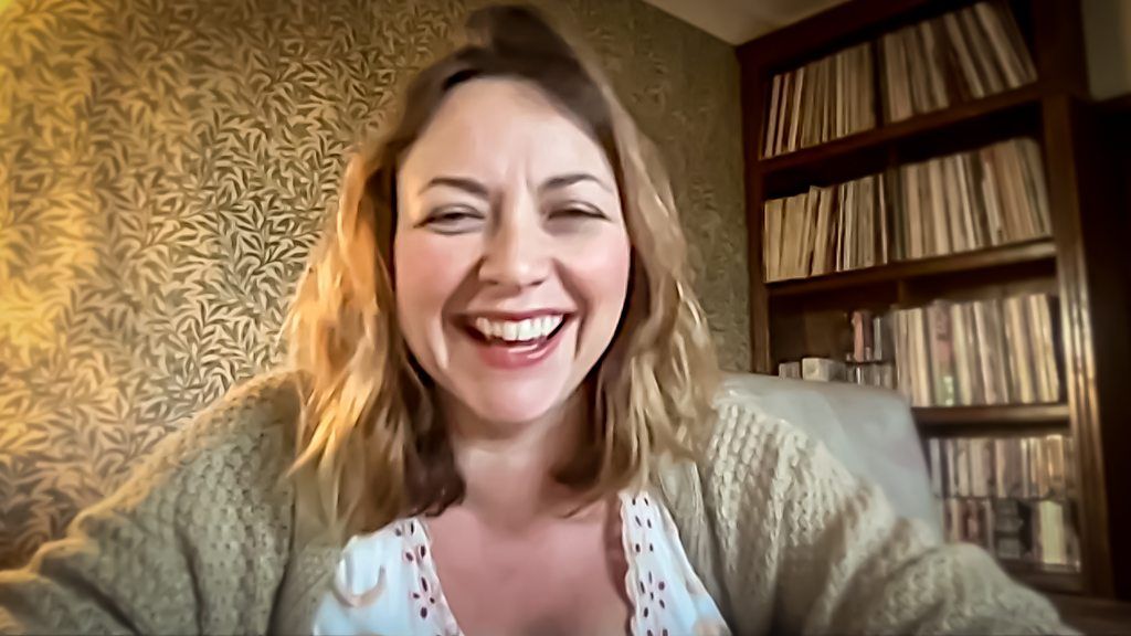 Charlotte Church in a room with a bookcase behind her