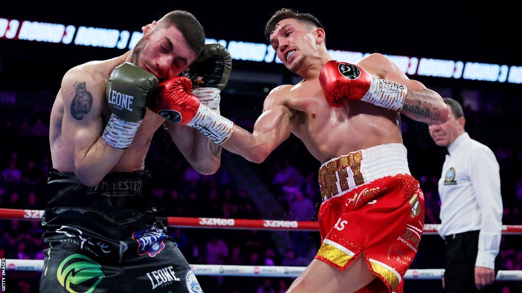 Liam Davies (right) lands an uppercut on his opponent Vincenzo La Femina in their European Super-bantamweight title fight