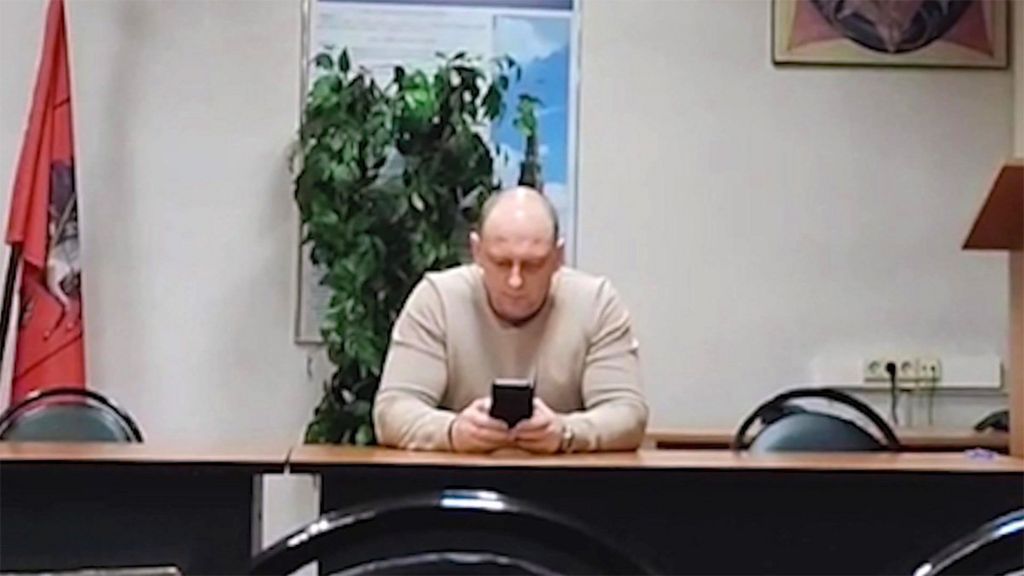 The "man in beige", Alexander Fedorinov, filmed sitting at a desk