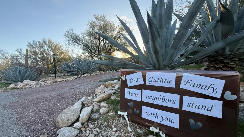 A signs stuck in front of a plant say 
