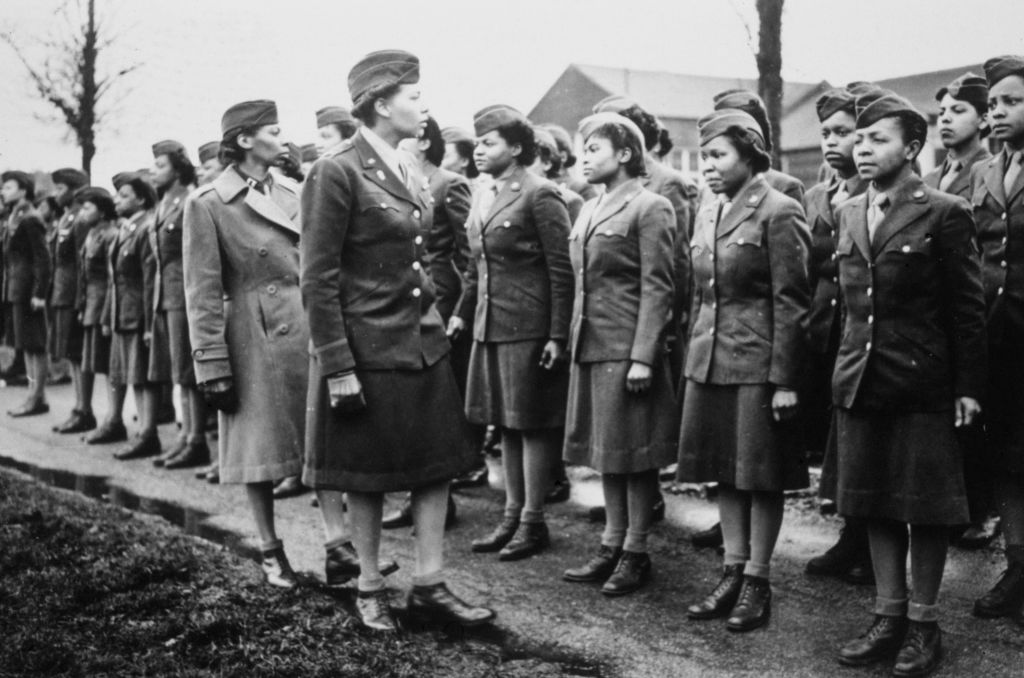 American Women's Army Corps (WAC) Captain Mary Kearney and American WAC Commanding Officer Major Charity Adams (1918-2002) inspect the unspecified first arrivals to the 6888th Central Postal Directory Battalion at a temporary post in Birmingham, West Midlands, England, 15th February 1945