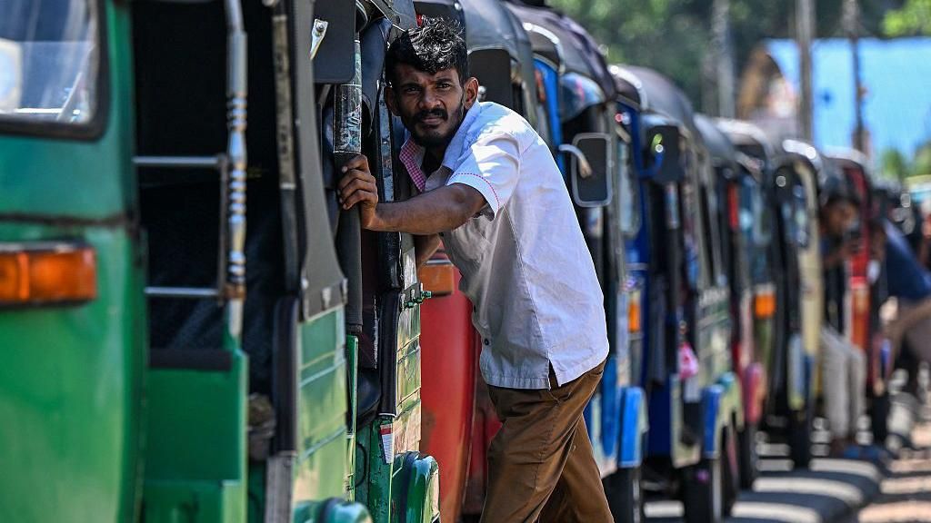 Drivers wait in a queue to refuel their auto rickshaws at a fuel station in Biyagama on the outskirts of Colombo on March 15, 2026.