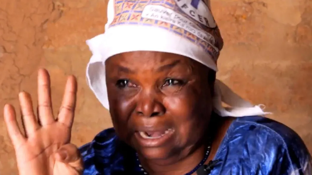 Yameogo Aminata in a blue address looks at the camera