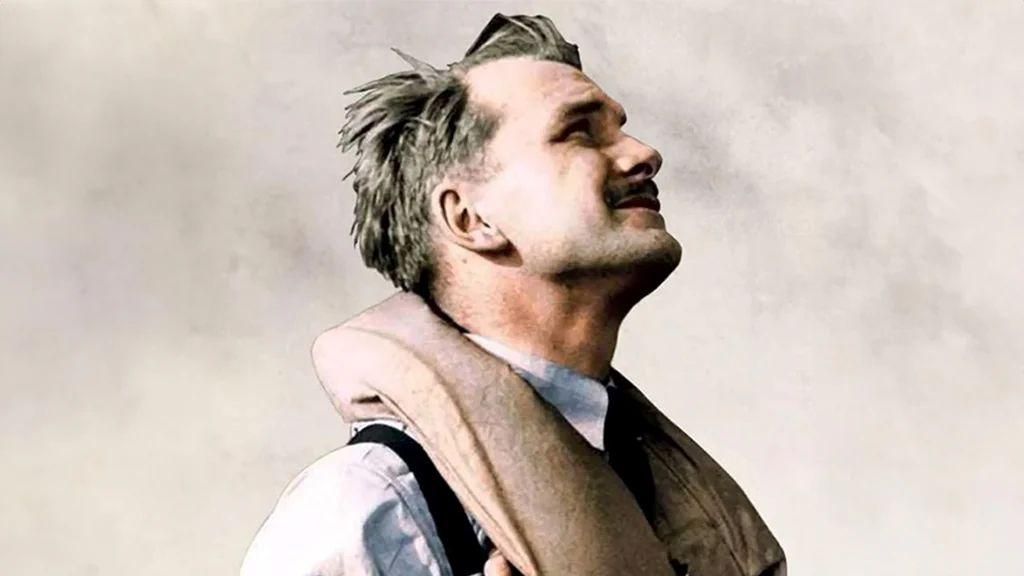 An older picture of John Hemingway in his younger days. He is looking up at the sky and has a buoyancy aid around his neck.