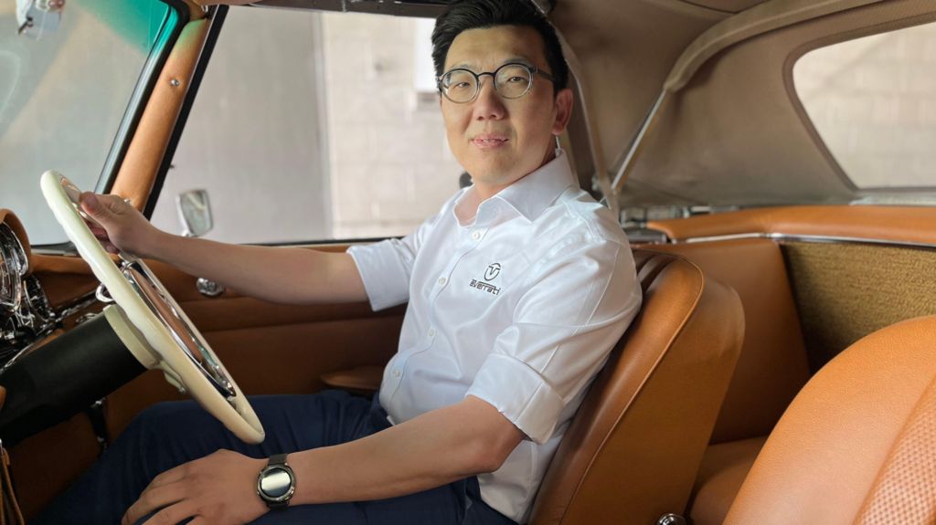 Tony Fong in the driving seat of a classic car