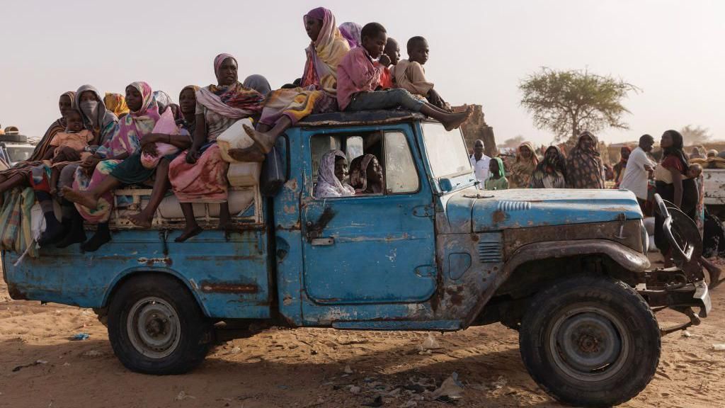 Newly arrived refugees from Darfur in Sudan, sit on a vehicle before being taken to a new camp on April 23, 2024 in Adre, Chad