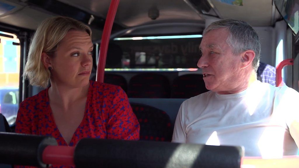 BBC reporter Hannah Miller and local man talking on a bus