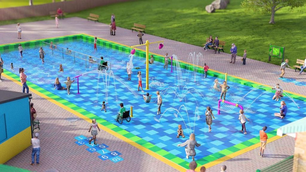 A computerised rendering of what the new splash park will look like. It includes a large blue tiled paddling pool with sloped access and a number of different fountains and types of play equipment. 