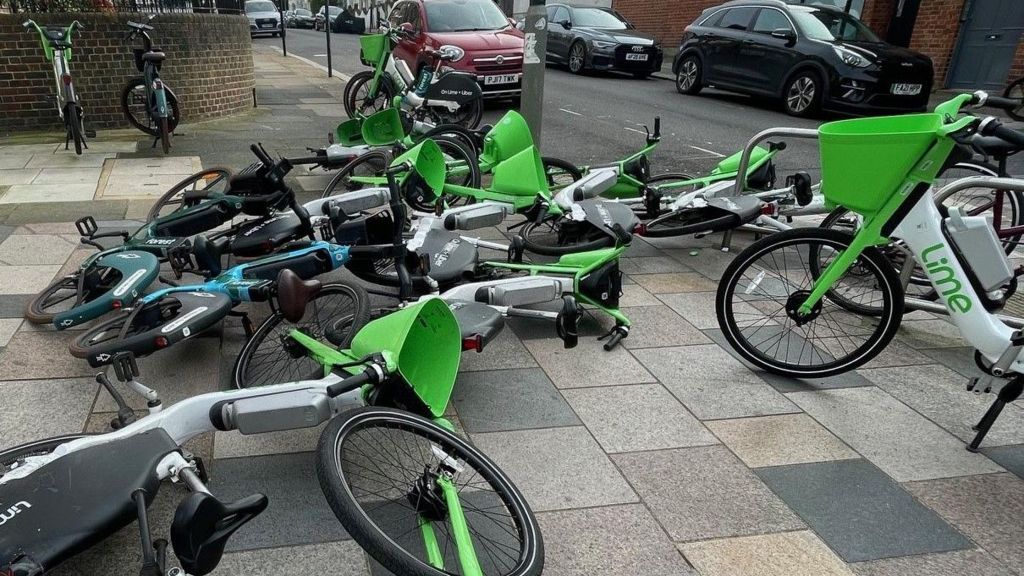 Image from April 2024 showing almost a dozen bikes blocking a pavement in Clapham Junction