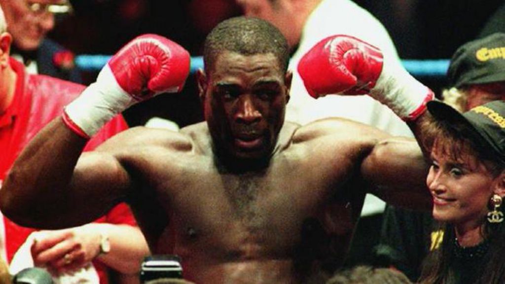 Frank Bruno in the ring, with gloved fists in the air, celebrating a victory