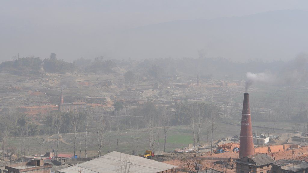 With the Himalayas in the background, brick kilns still belch out smoke