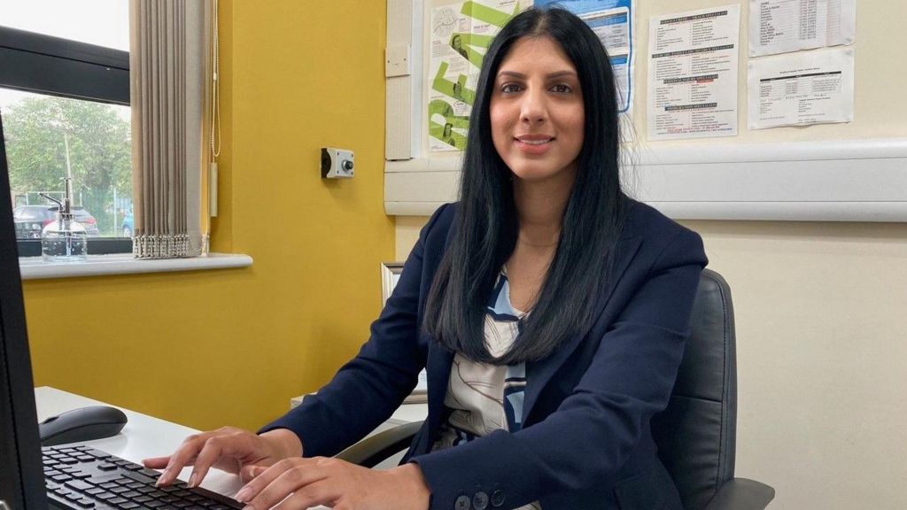 Dr Sofia Buncy sitting at her desk in the Khidmat Centre in Bradford