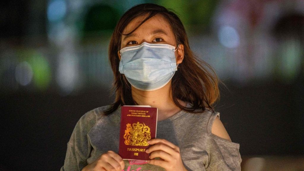 A woman in Hong Kong holding a British National Overseas passport.